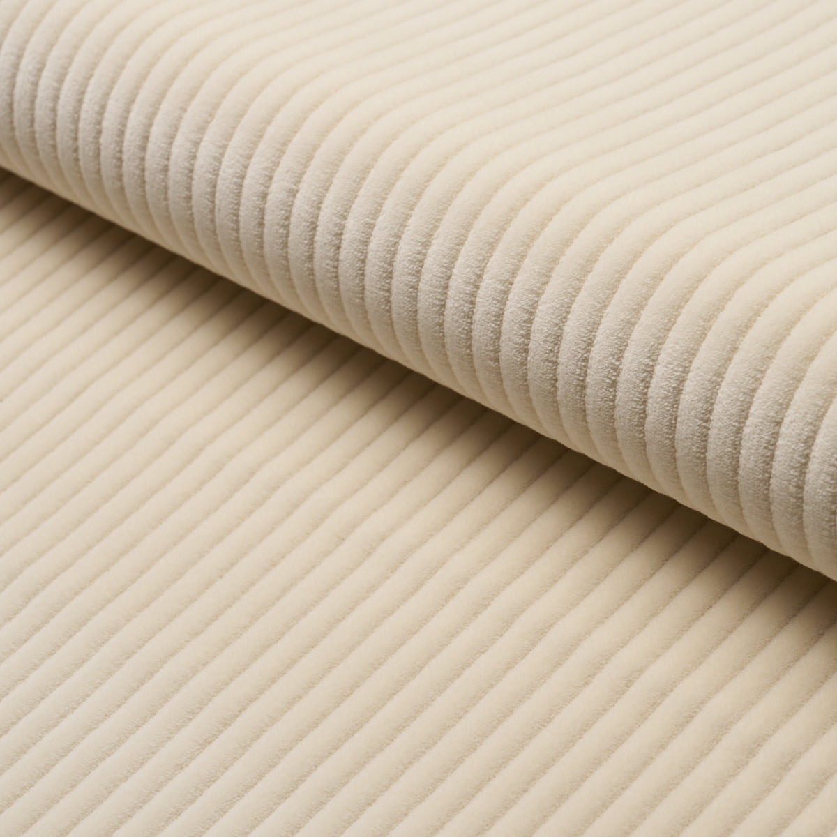 Beige corduroy fabric close-up with soft, ridged texture.