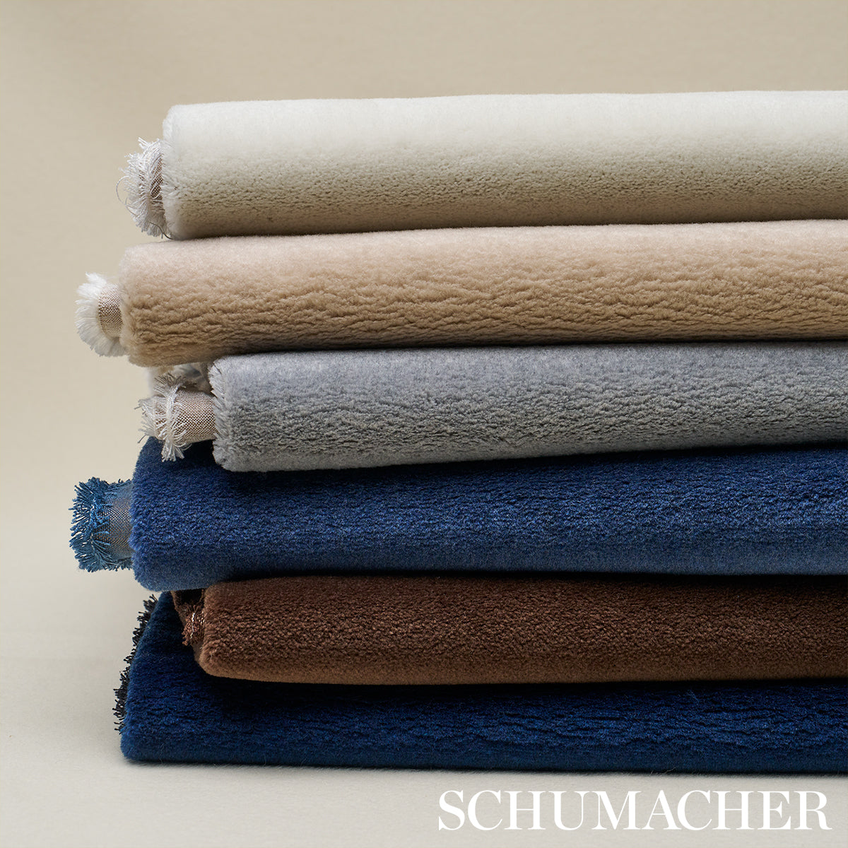 Virgin wool texture swatches in ivory, beige, light gray, blue, brown and navy with fringed ends.