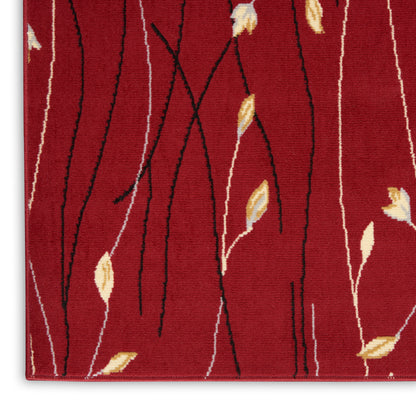 Red rug close-up featuring black wavy lines and small cream-yellow leaves in a modern botanical pattern.