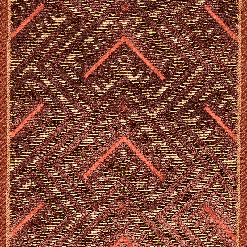 Textured woven rug with bold chevron diamonds in maroon, olive and coral pink hues.