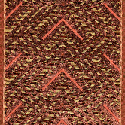 Textured woven rug with bold chevron diamonds in maroon, olive and coral pink hues.