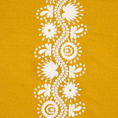 Mustard yellow fabric with white floral lace embroidery running vertically in a center stripe.