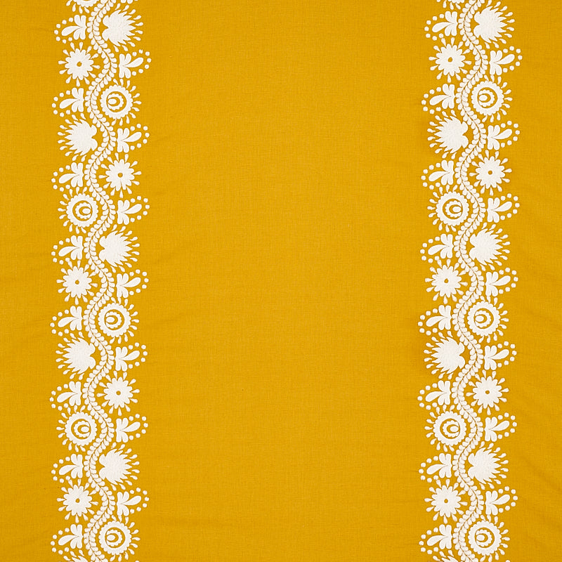 Mustard yellow fabric with white floral lace borders down both sides.