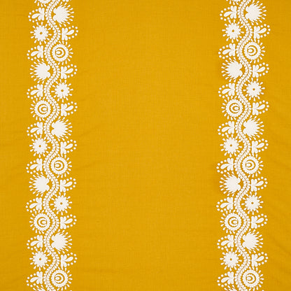 Mustard yellow fabric with white floral lace borders down both sides.