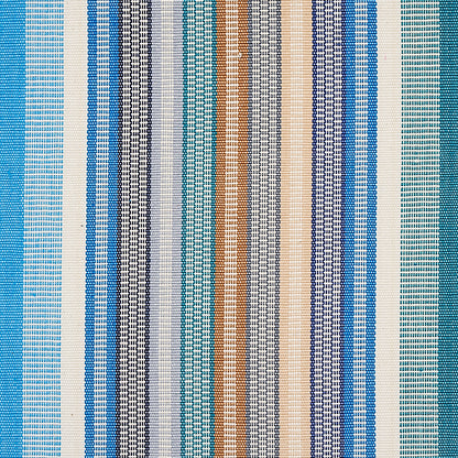 Multicolor vertical striped woven fabric in blues, teals, beige and brown; textile swatch for upholstery or apparel.