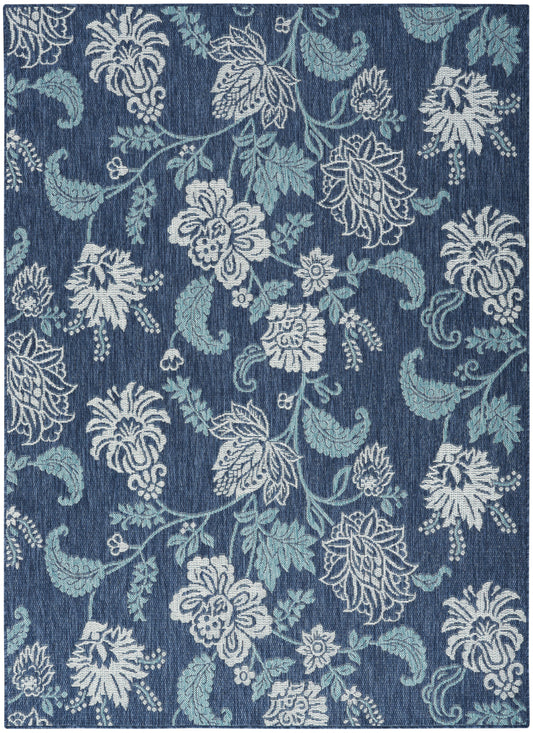 Blue floral damask rug with white and light-blue blossoms and vines; rectangular home decor.
