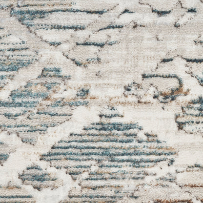 Distressed ivory rug with blue-gray geometric pattern; modern Moroccan-inspired design and soft textured surface.