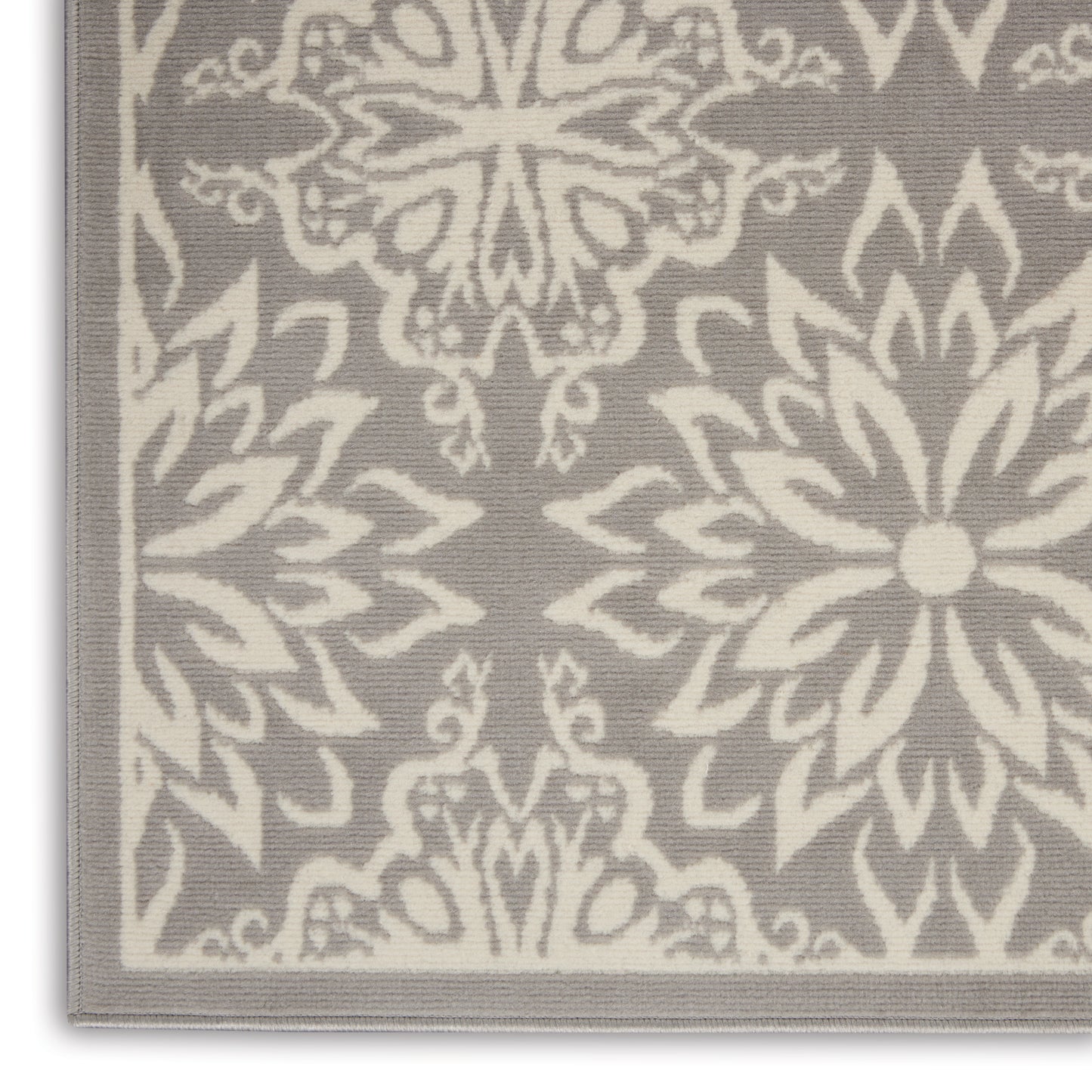 Grey fabric with ivory damask floral pattern & pale grey border trim, close-up view.