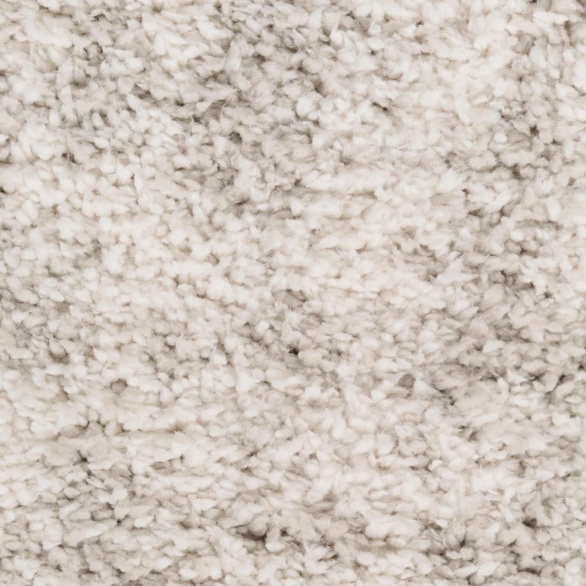 Cream shaggy rug with dense fluffy pile; plush beige floor covering.