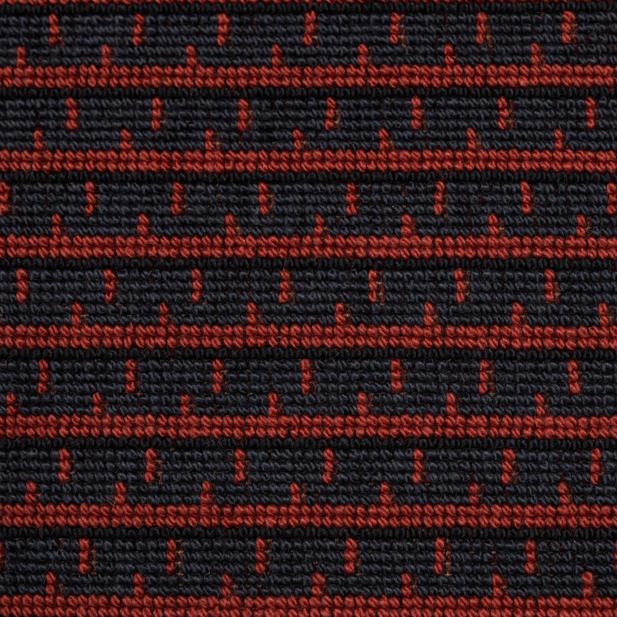 Dark navy woven fabric with red dotted horizontal stripes; textured textile for upholstery.