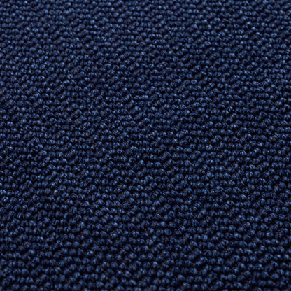 Close-up of dark blue loop-pile carpet with dense, textured fibers.