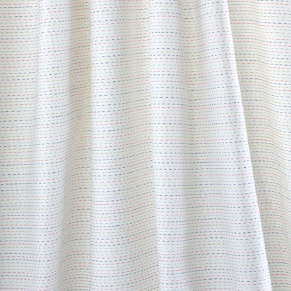 White fabric curtain with fine blue and red dashed stripes, soft folds.