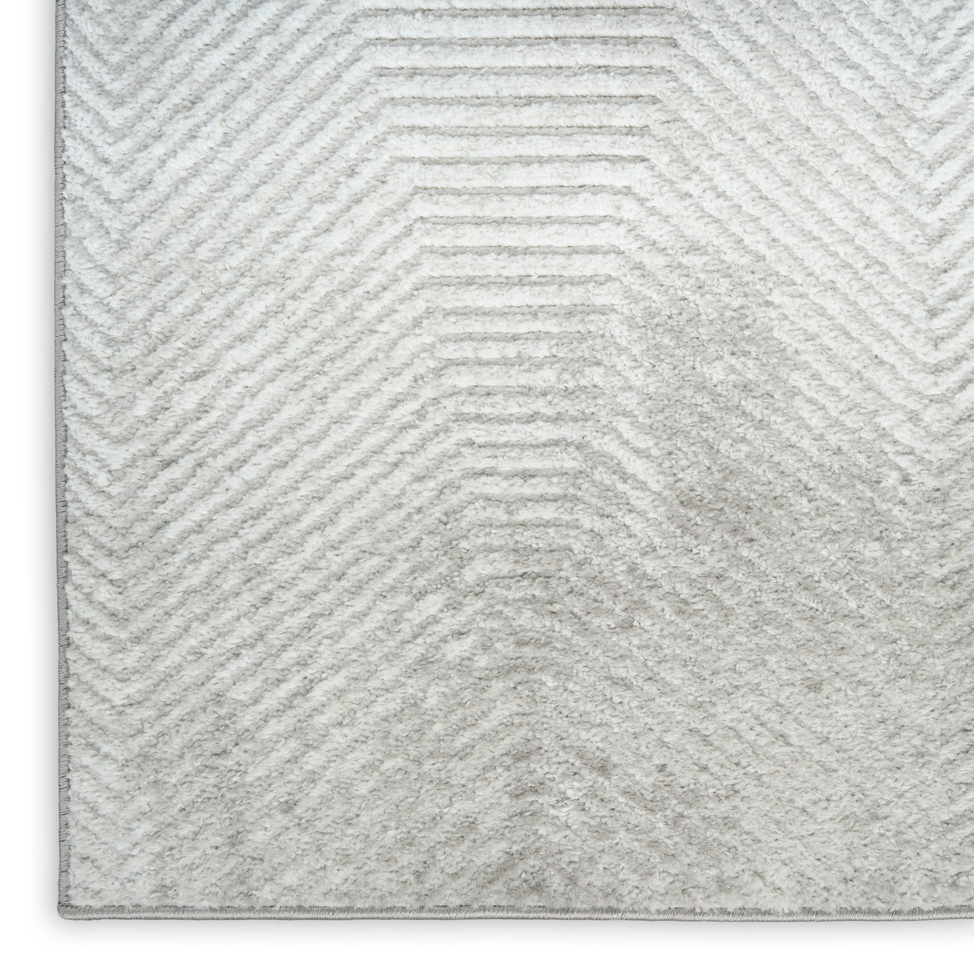 Light gray rug with a raised chevron pattern and plush pile.