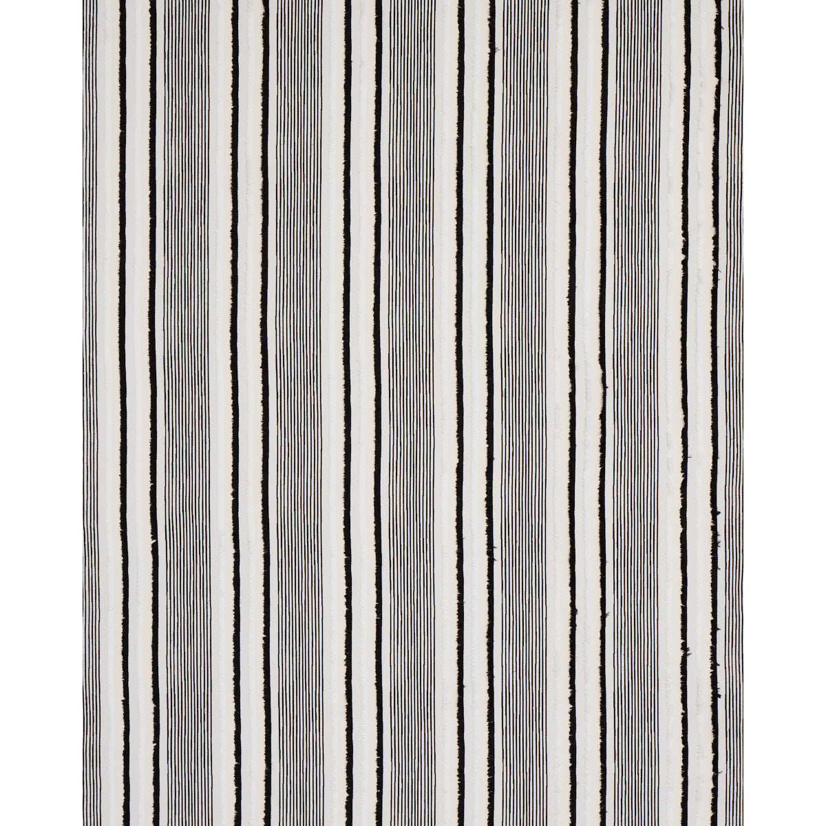 Vertical striped rug with black & gray lines on white; modern woven textile for living room decor.