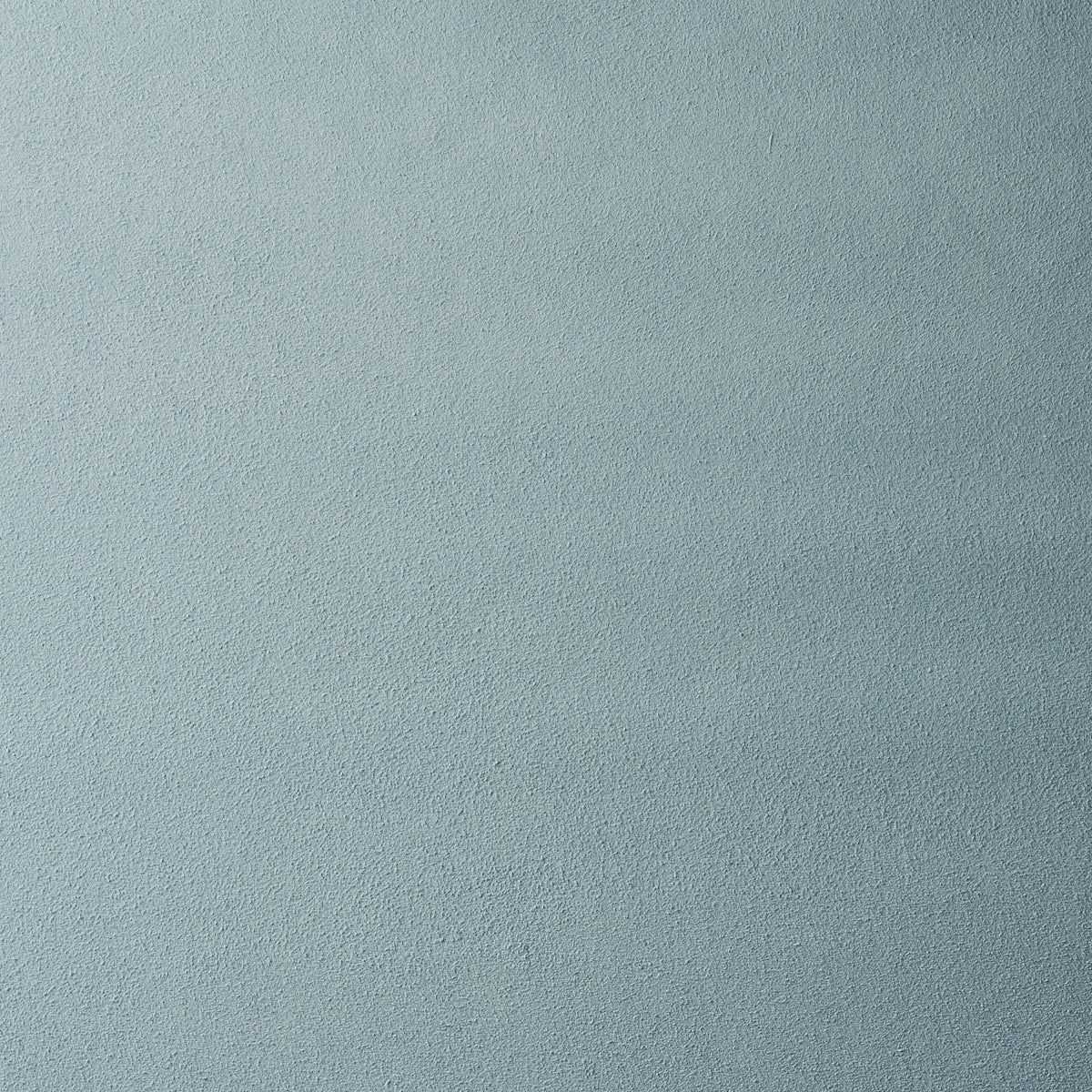Light blue-gray textured fabric surface with a soft suede-like finish.