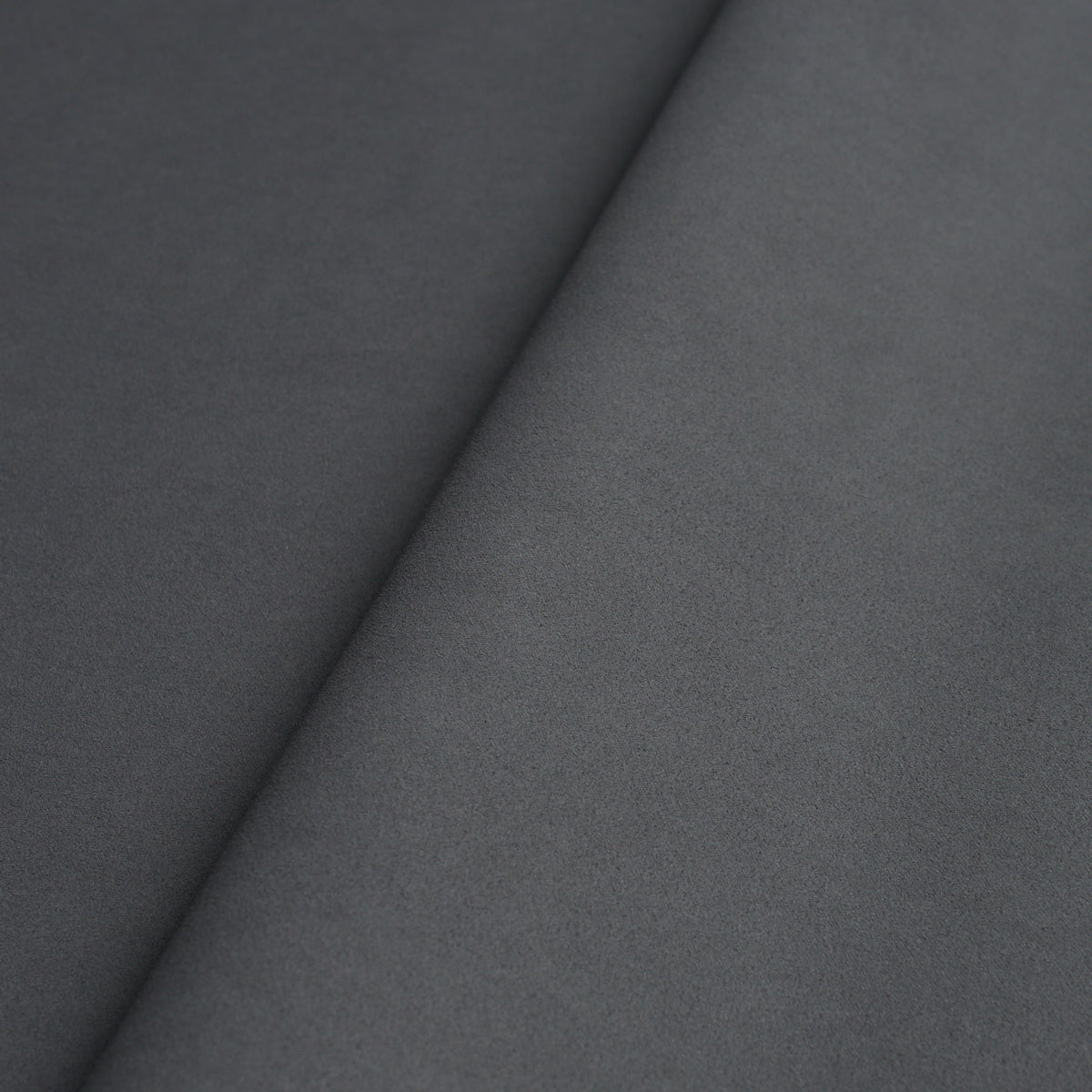 Dark and medium grey vegan leather panels with a diagonal seam and soft matte texture for upholstery or apparel.