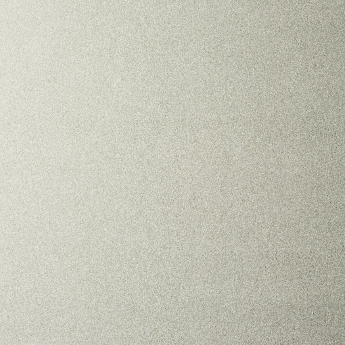 Cream-beige textured wall surface with subtle grain.
