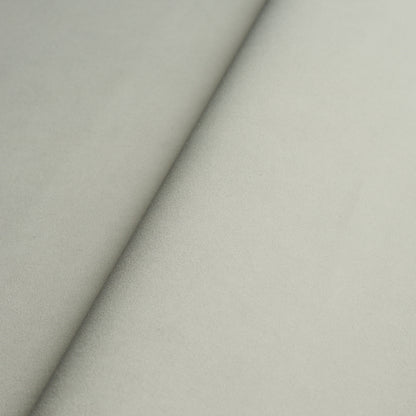 Beige suede-like fabric swatch with a diagonal seam, soft nap; ideal for upholstery or fashion.