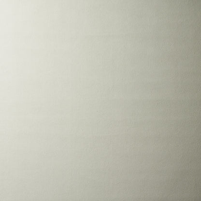 Cream-beige textured surface with subtle horizontal grain; linen-like backdrop.