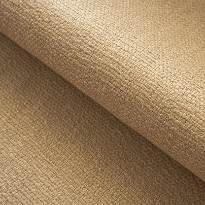Beige woven fabric close-up with a tight grid-like weave; rolled sheet, natural rustic upholstery or craft material