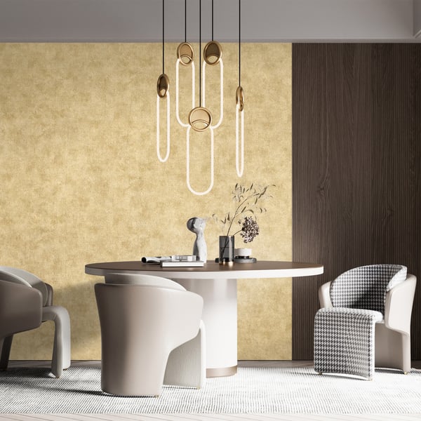 Interior scene featuring beige walls with dark wood paneling and gold cord wallpaper; modern round white pedestal table with a dark top, grey upholstered chairs, and pendant lights.