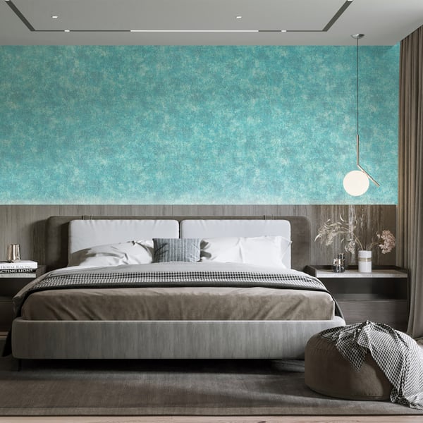 Modern bedroom with green textured wallpaper on the wall, gray upholstered king bed, white pillows, round pendant light, and gray pouf.