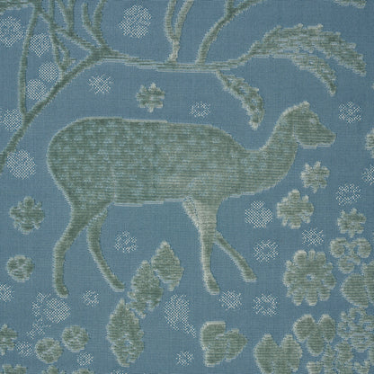 Blue tapestry-style upholstery fabric with sage deer silhouette, branches & floral motifs in a woven jacquard pattern.