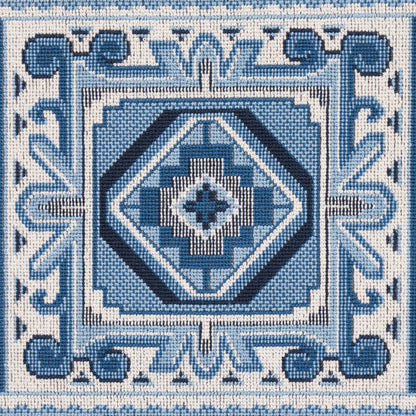 Blue and white woven textile featuring nested diamond patterns, square frames, and an ornate scroll border.