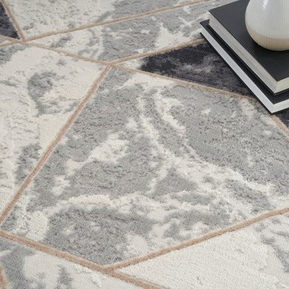 Gray and white marbled area rug; a small stack of books and a white vase sit nearby.