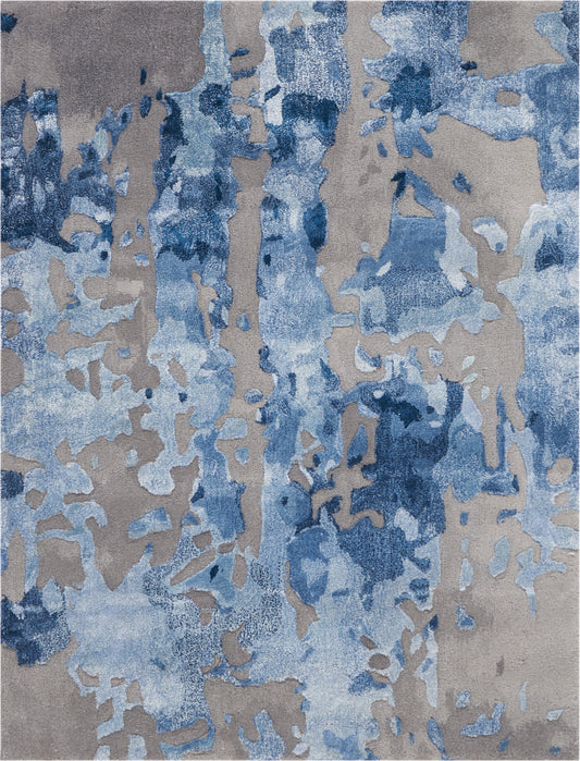 Abstract blue-toned area rug with irregular azure patches on a warm gray-beige backdrop; modern contemporary design.