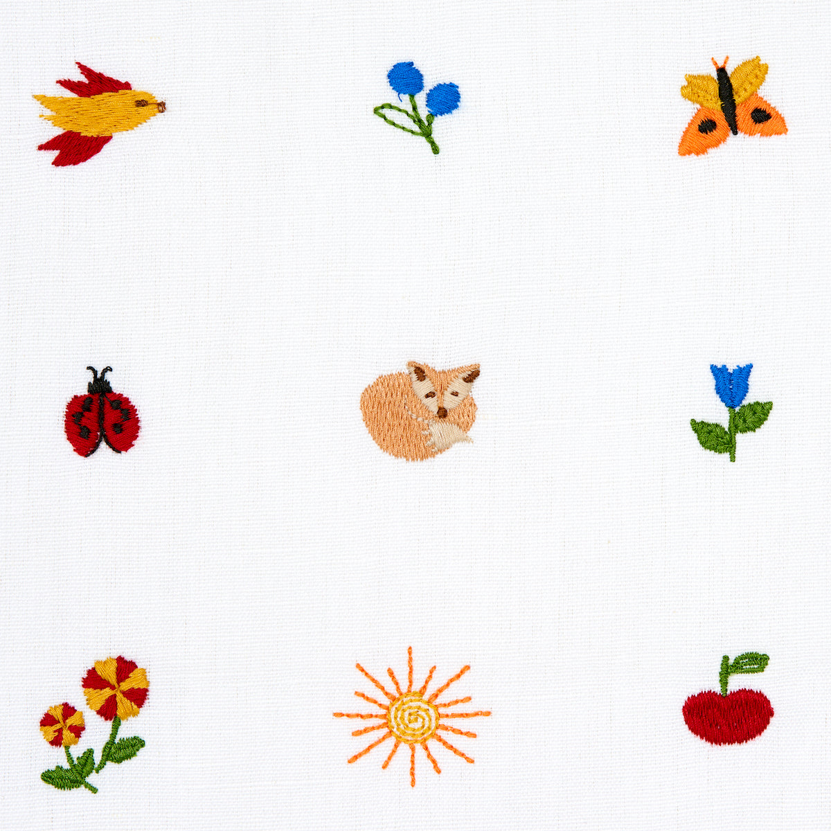 Cross-stitched on white fabric, 3x3 grid of colorful motifs: bird, butterfly, flowers, ladybug, cat, sun, apple.
