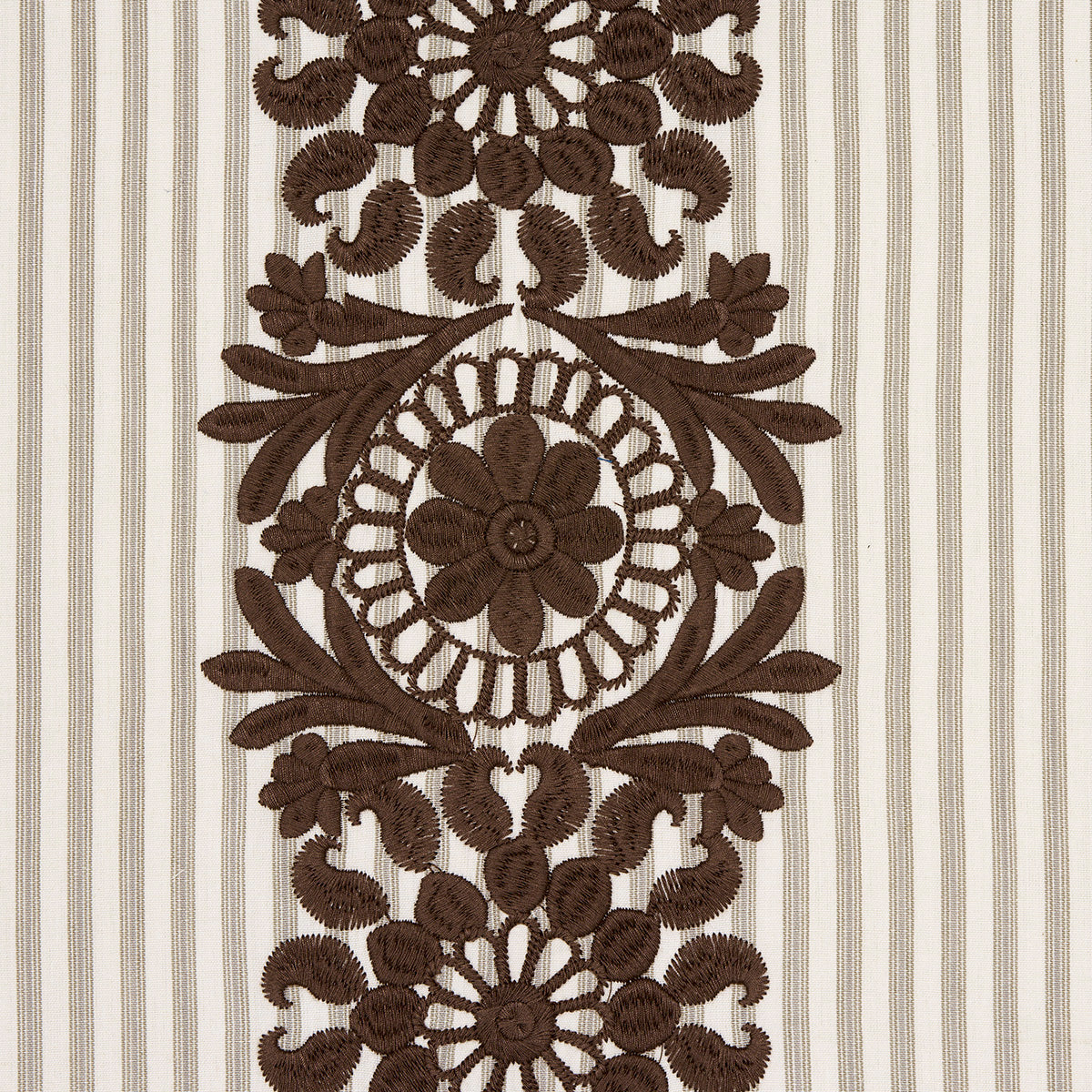Brown embroidered floral medallion pattern with circular flower motif and leafy scrolls on beige striped fabric.