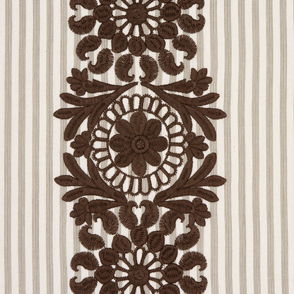 Brown embroidered floral medallion pattern with circular flower motif and leafy scrolls on beige striped fabric.