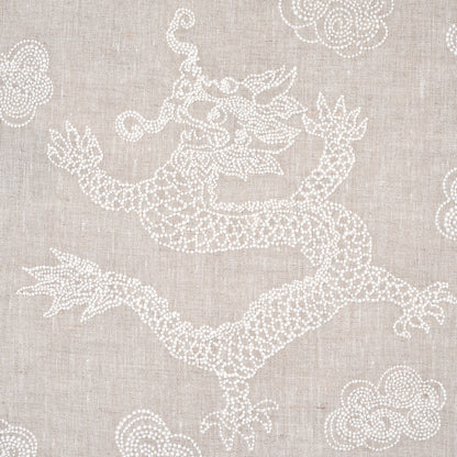 Beige linen fabric featuring white embroidered dragon with clouds; decorative textile design.