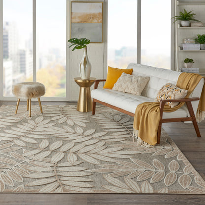 Modern cozy living room: beige-gray leaf-pattern woven rug, white mid-century sofa, mustard throw, warm wood accents and plants.