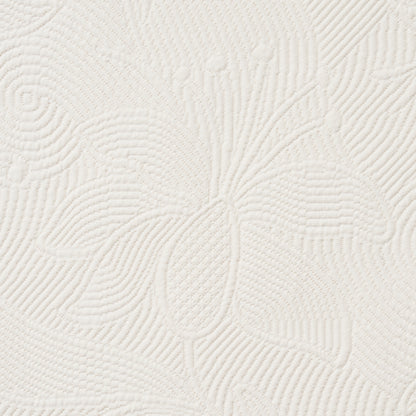 Cream textured fabric with raised floral leaf motif and a quilted look; ideal for upholstery.