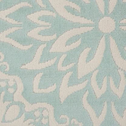 Light blue woven rug with a white damask floral pattern; elegant floor rug.