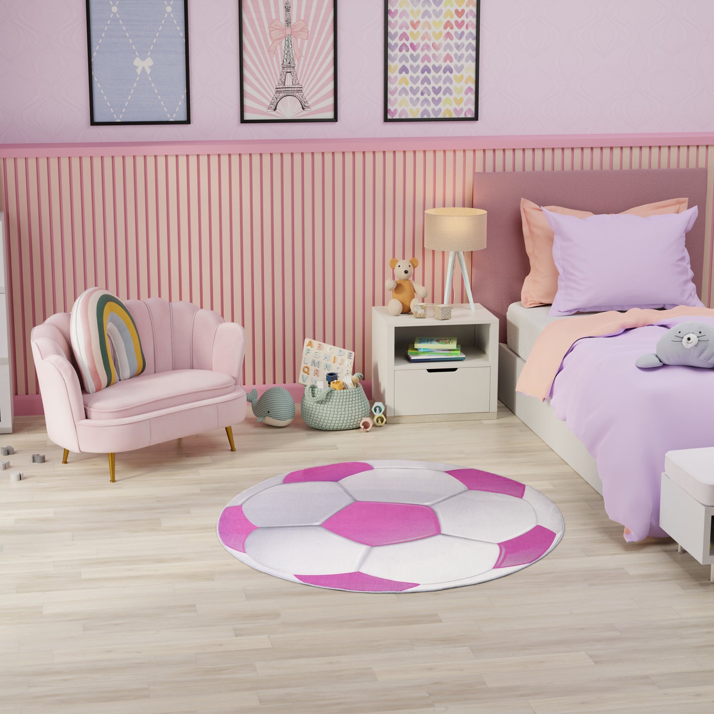 Pastel pink kids' bedroom with round white-pink patchwork rug, pink curved chair, lavender bedding, white nightstand, and toys.