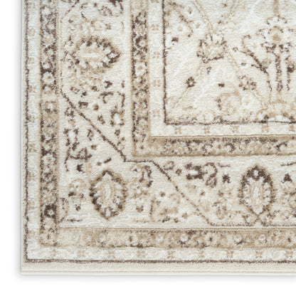 Corner view of a cream and taupe Persian-style area rug with ornate floral borders.