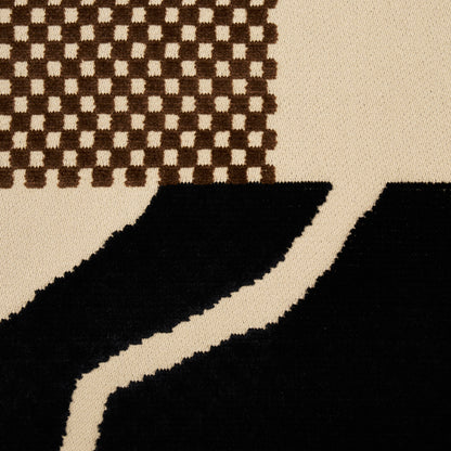 Beige textile with brown checker pattern in top left and large black curved shapes across the lower area.