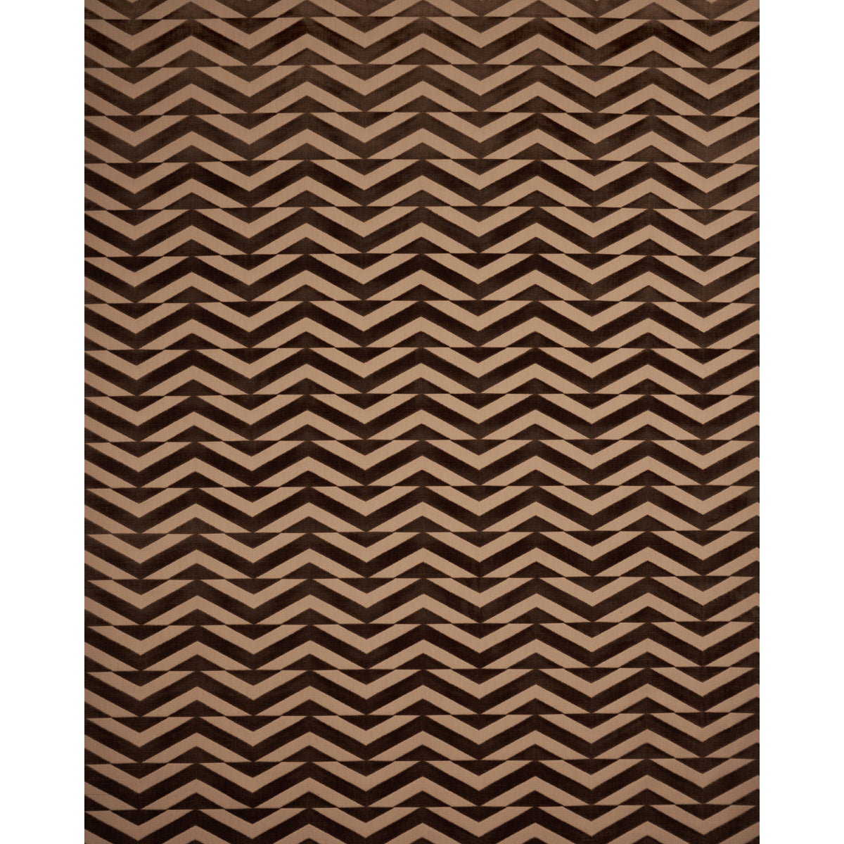 Dark brown and beige chevron patterned rug with bold zigzag geometric design.