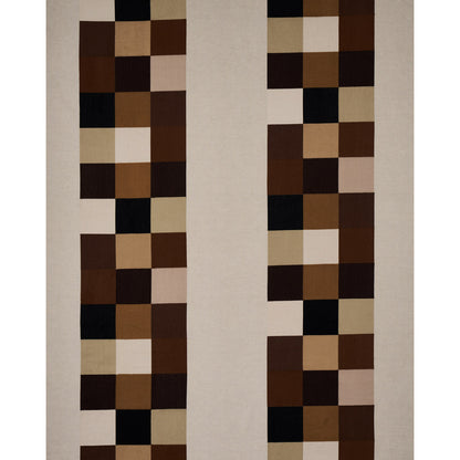Geometric beige rug with two vertical columns of brown, tan and cream squares on a light background.