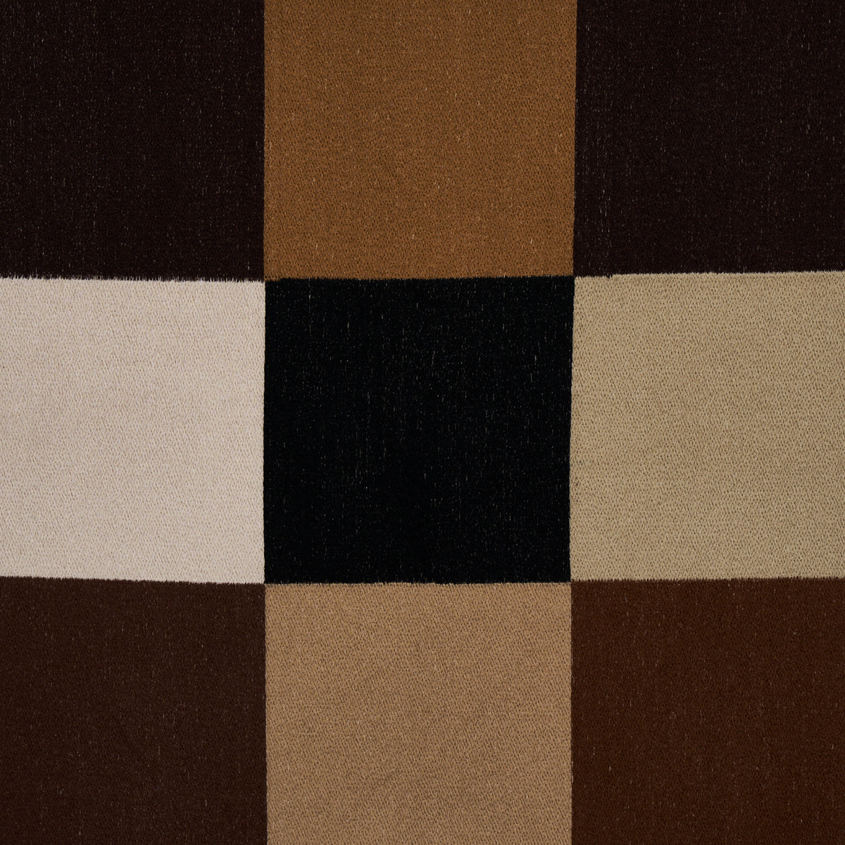 3x3 patchwork textile of brown, tan, beige, cream and black squares; geometric rug or upholstery fabric.