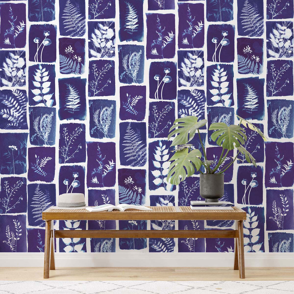 Navy botanical wall mural with white leaf silhouettes.