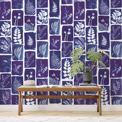 Navy botanical wall mural with white leaf silhouettes.