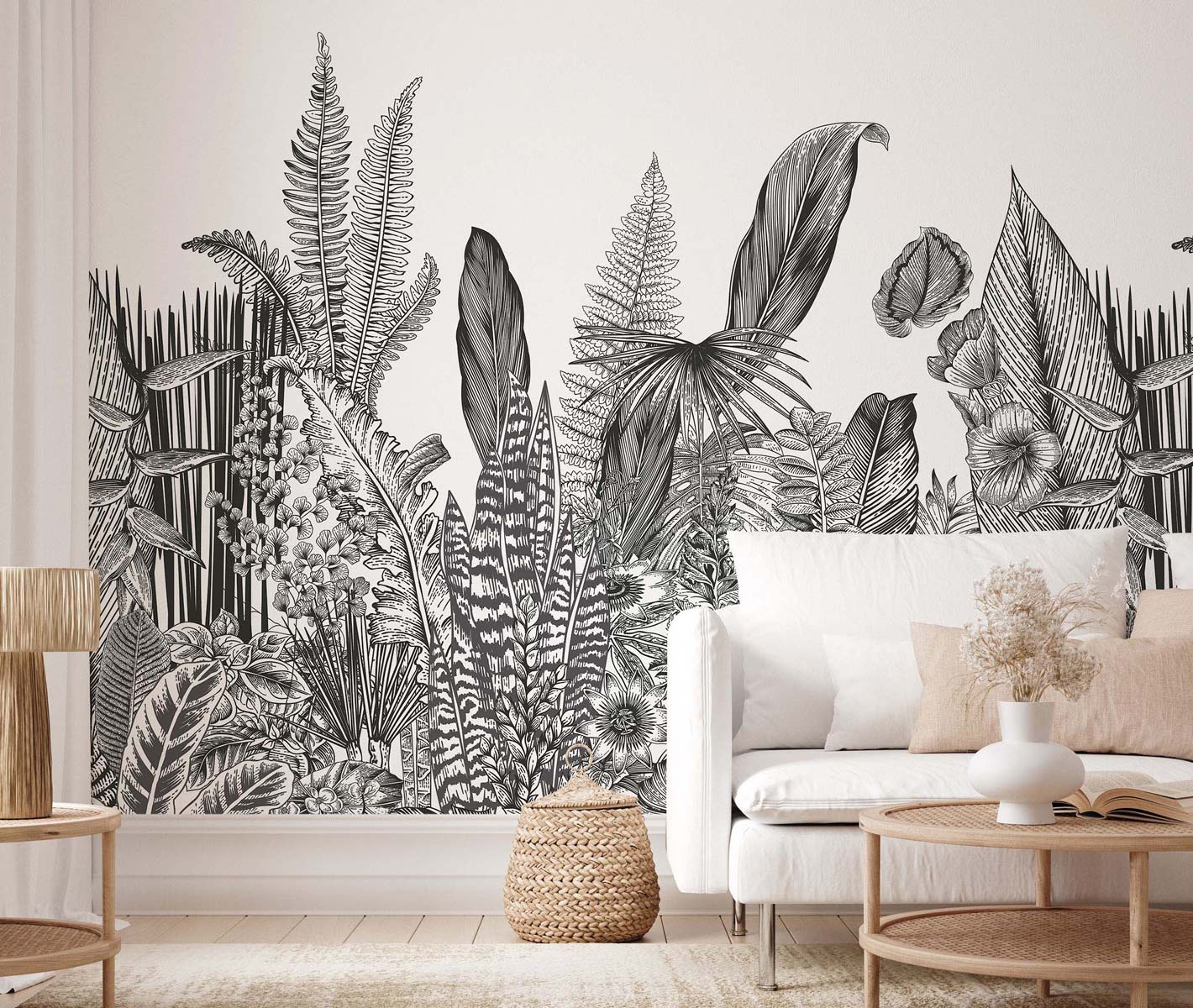 Living room with a black-and-white tropical plant mural, white sofa, and light-wood coffee table.
