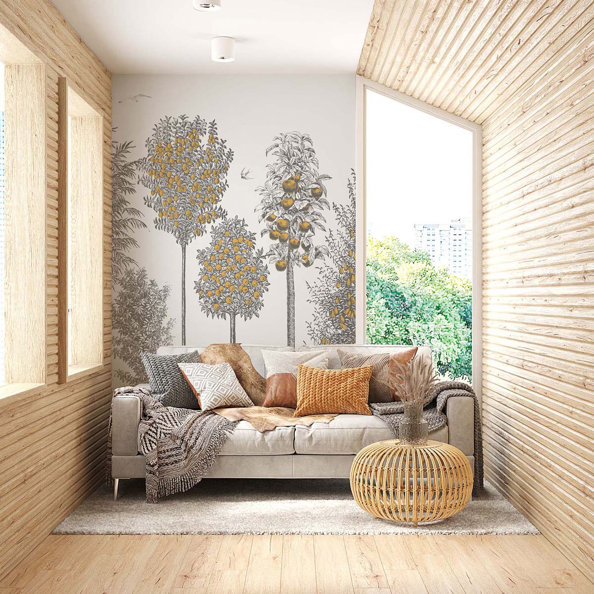 Bright wood-paneled living room with gray sofa, orange cushions, round wicker table, tree mural, large window view.