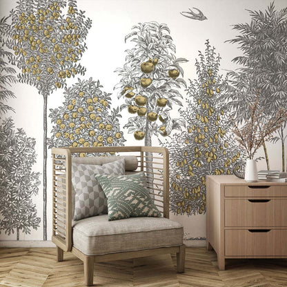 Living room with gray-yellow lemon-tree mural, beige cushioned wooden armchair with green/gray pillows, and a light wood dresser.