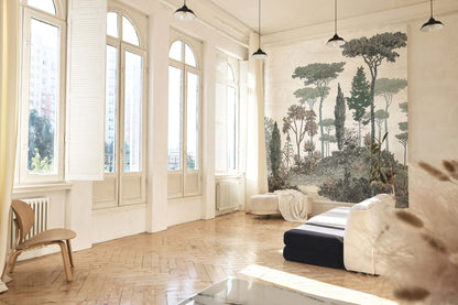Bright living room with arched windows, herringbone wood floor, white walls, gray nature wall mural, white sofa with navy cushions.
