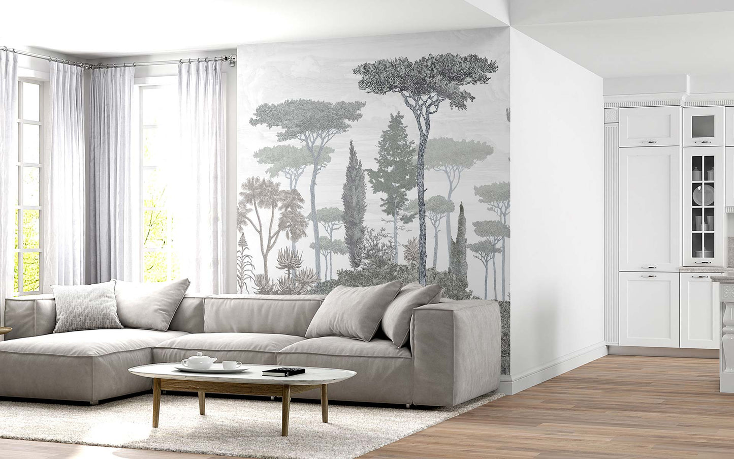Modern living room with a light gray sectional sofa, oval wooden coffee table, tree mural wall, and white cabinetry.